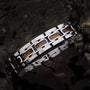 "Tremolo" bracelet in walnut and silver, featuring a sleek, modern design.