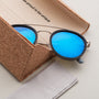 "The Enchanting" sunglasses featuring a stylish design with blue lenses and antique silver frames.