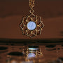 "Composition Necklace" necklace features a gold design with a blue nacre centerpiece, reflecting elegance and sophistication.