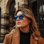 "The Enchanting" sunglasses, featuring a stylish Leadwood and Antique Silver design with striking blue lenses.