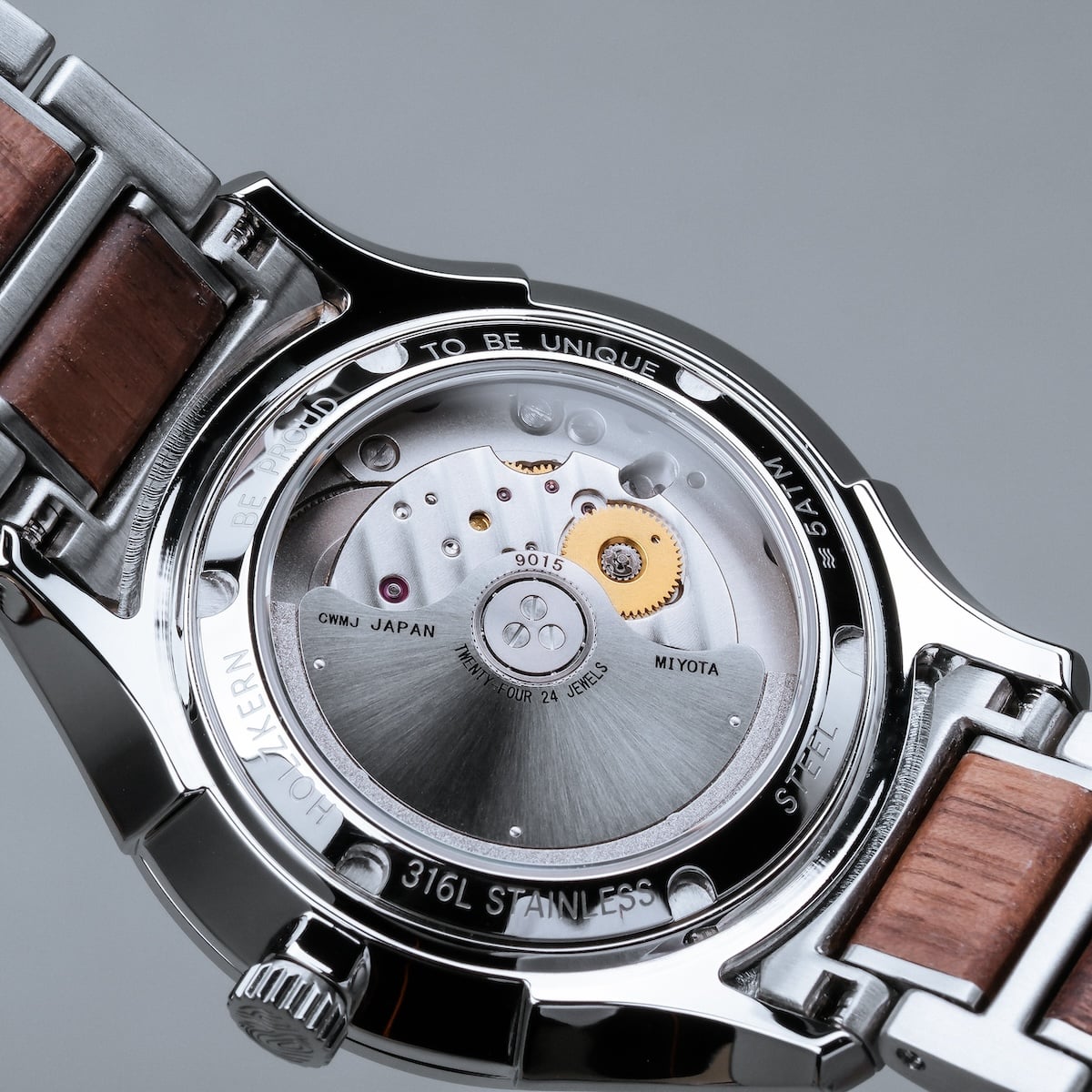 "Milestones watch highlighting elegant walnut and blue design details, showcasing intricate mechanical movement."