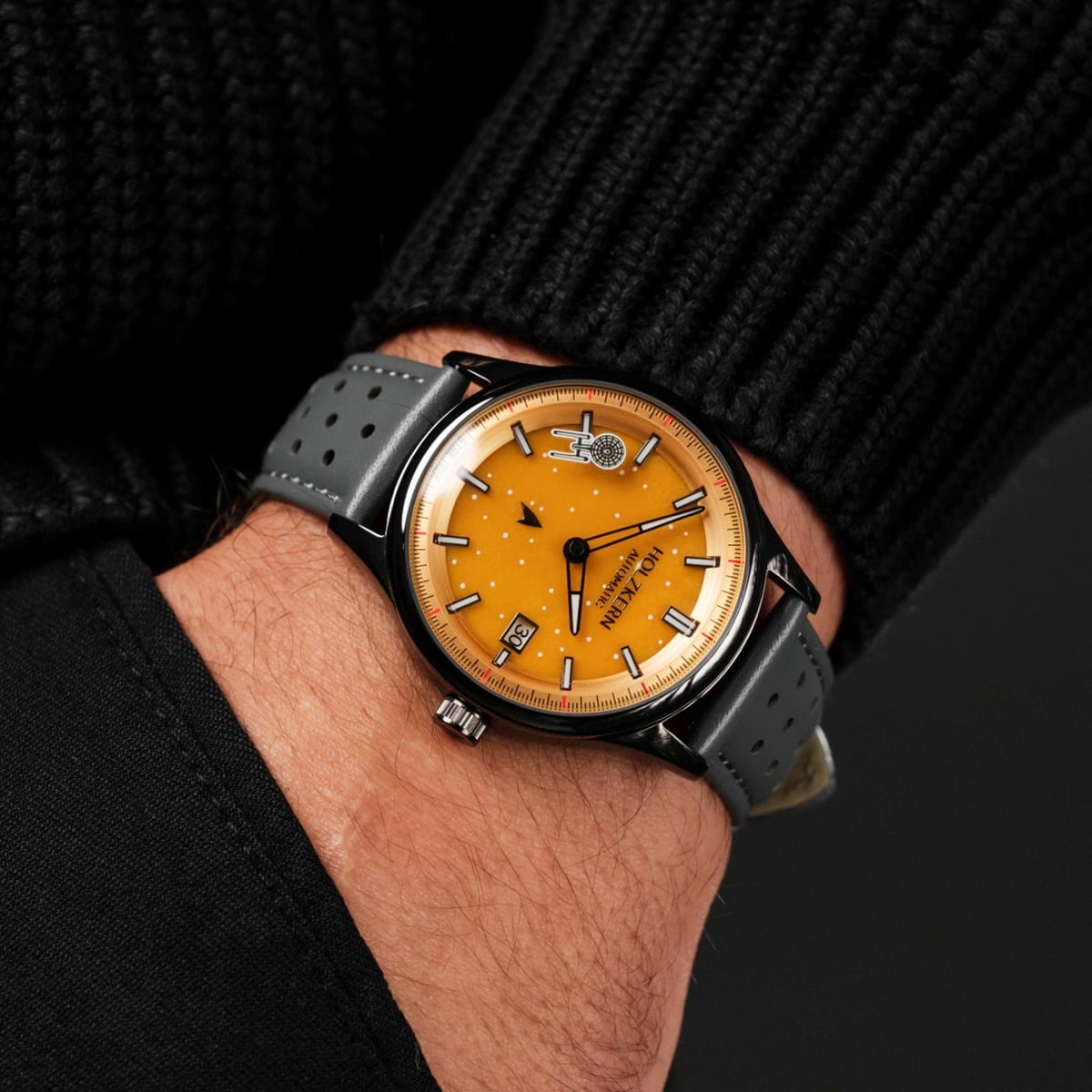 "NCC-1701" wristwatch with a jade/dark gray strap and vibrant orange dial.