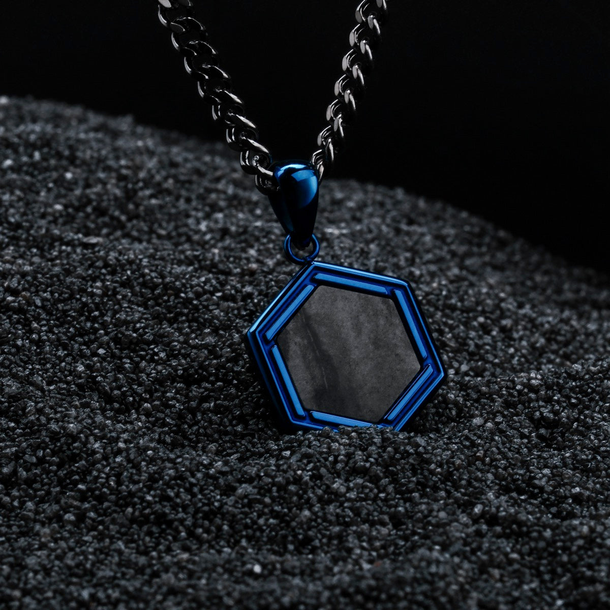 "Axis Necklace" necklace featuring a hexagonal pendant in Picasso Jaspis with a sleek blue design.