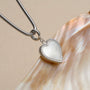 "Amorance Necklace" heart necklace featuring a nacre pendant with silver accents, showcasing elegant and sophisticated design.