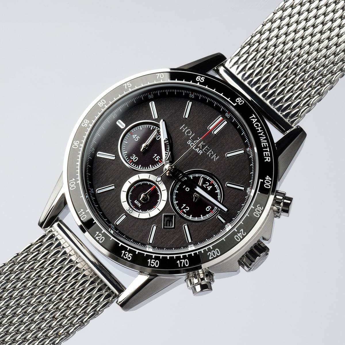 "Comfort Crusher", a sleek watch with a maple face and silver mesh strap, combines elegance and functionality.