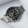 "Comfort Crusher", a sleek watch featuring a maple dial and silver mesh band.