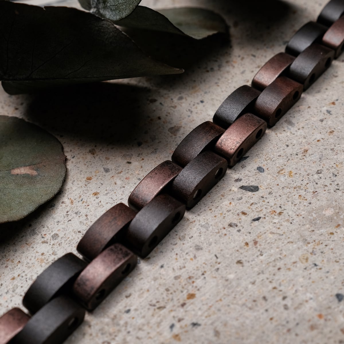 "Rondo" armband, met esdoorn en antieke koperen schakels, toont een rustieke en elegante visuele stijl.