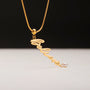 "Believe-Charm", a gold charm necklace featuring a pearl accent, elegant cursive design.
