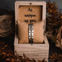 "Tremolo" watch in elegant walnut and silver, showcased in a natural-themed wooden box.