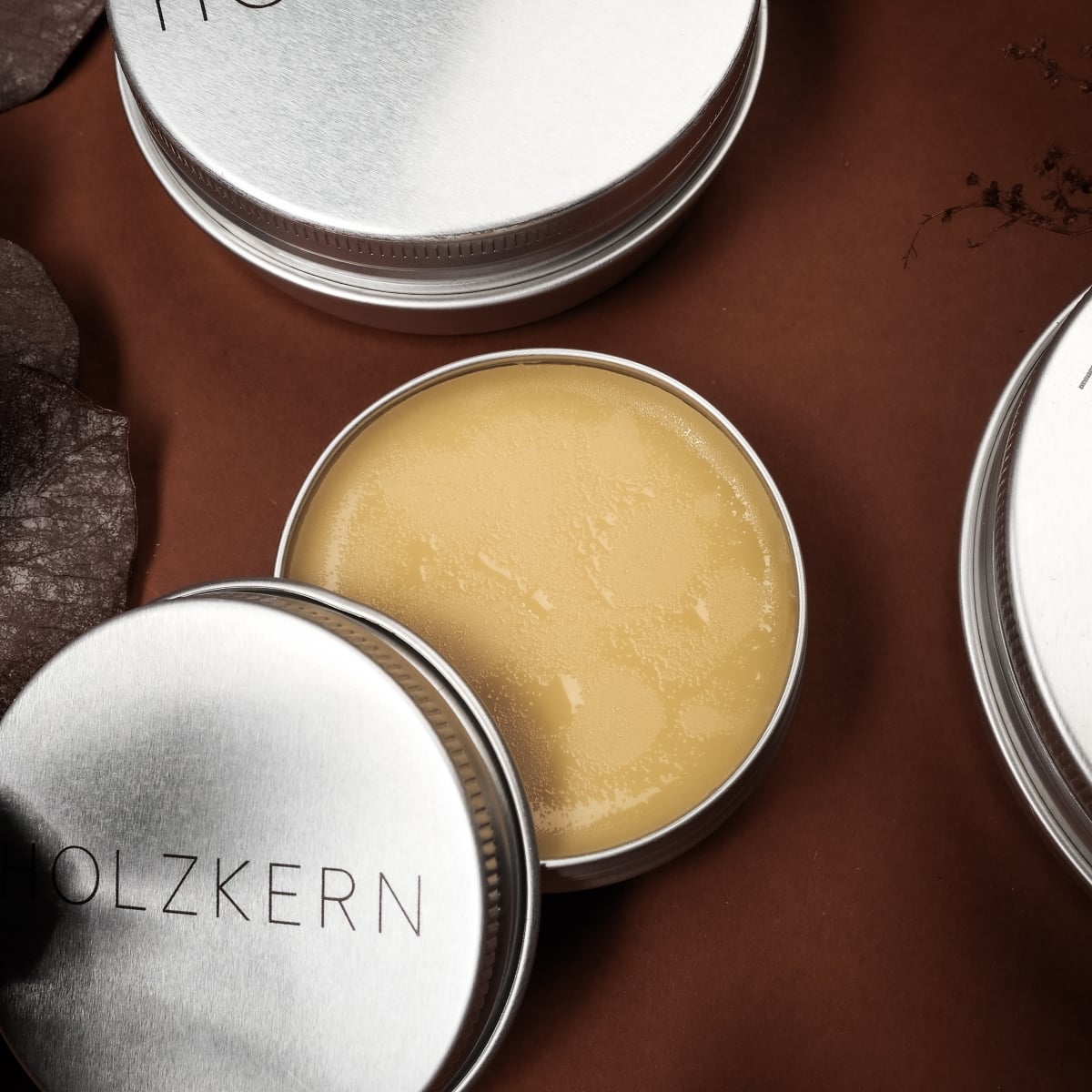 "Wood Care Balm 100ml" tin, an elegant wood care balm with a smooth texture and sleek metal packaging.