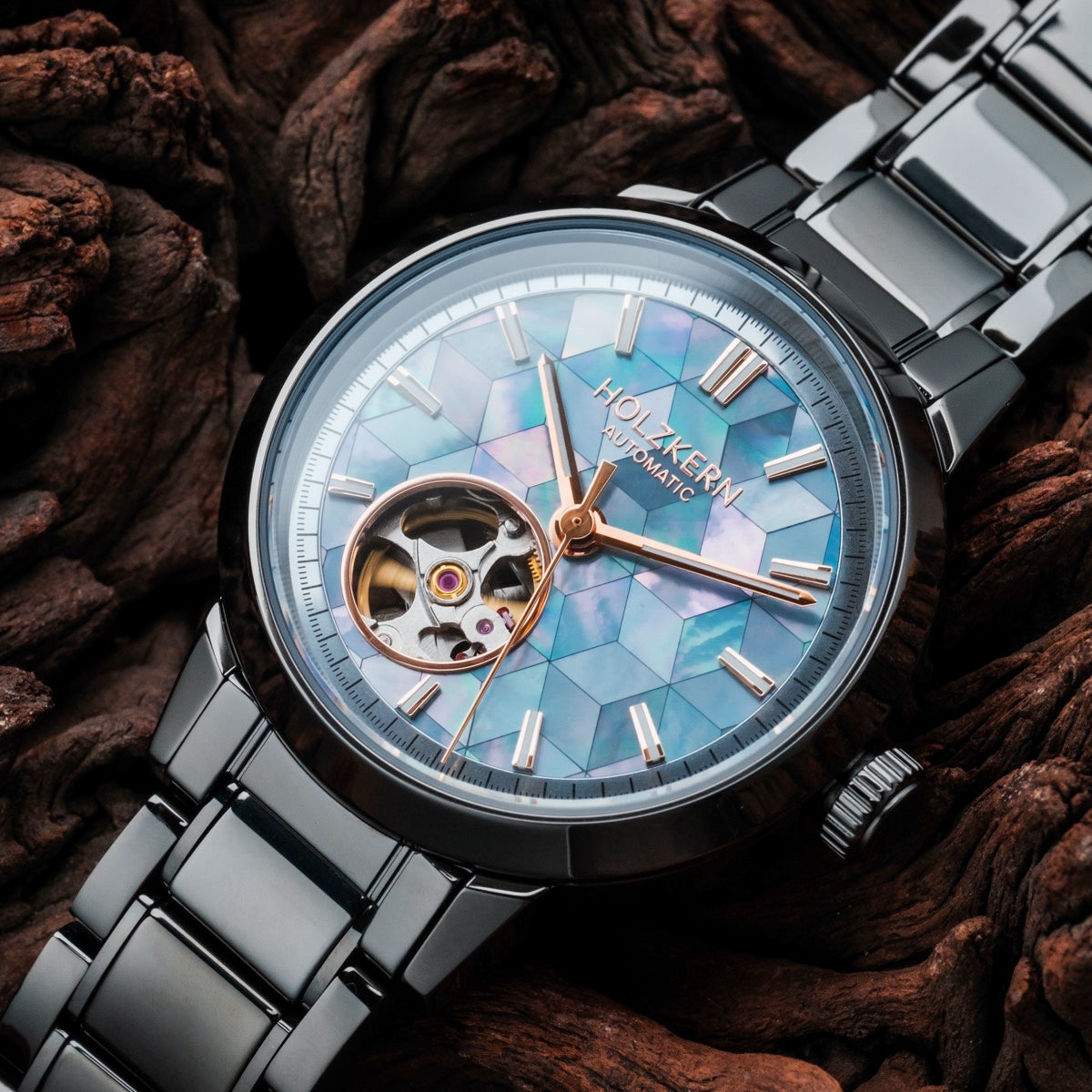 "Mirrordance" watch featuring a nacre ceramic design with an elegant open-heart dial against a wooden background.