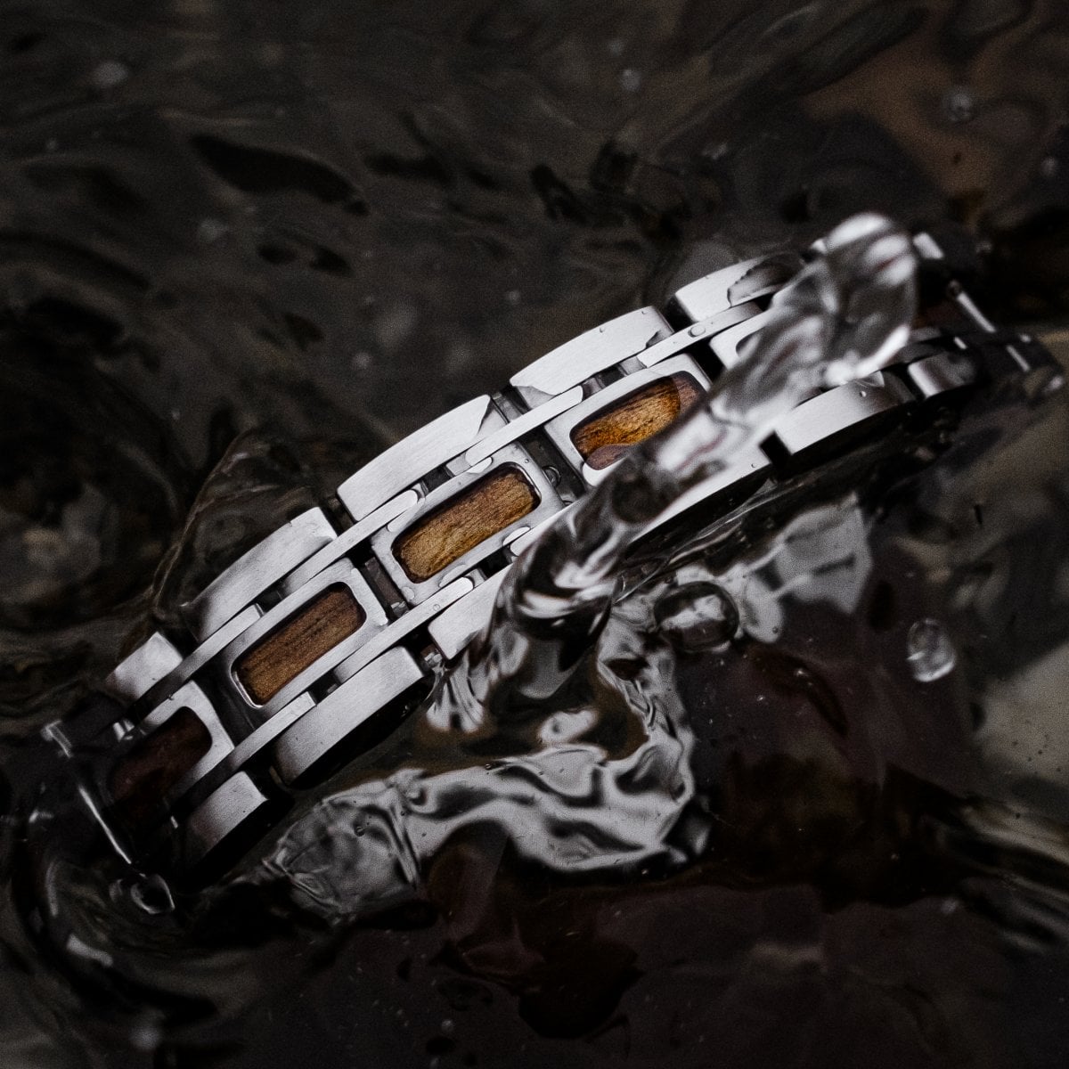 "Tremolo" bracelet features a sleek walnut and silver design with a modern, elegant style.