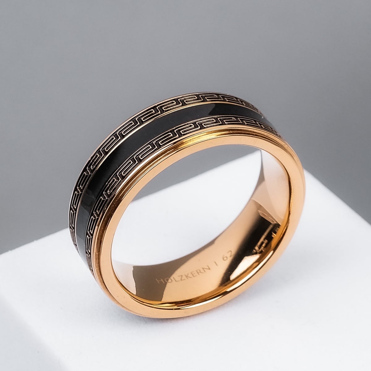 "Numerary Ring": A sleek ring featuring maple accents and gold detailing with an elegant geometric pattern.