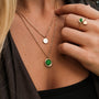 "Zendala Necklace" necklace showcasing a green nacre pendant with gold accents in a stylish layered design.