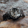 Woodleigh watch featuring a maple and black design with a skeleton dial and elegant metal bracelet.