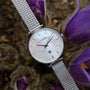 Piccolo watch with nacre dial and silver mesh band, elegant and sophisticated style.