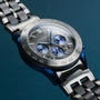 "Intergalactic watch featuring a sleek design with a marble dial and leadwood accents on a metallic band."