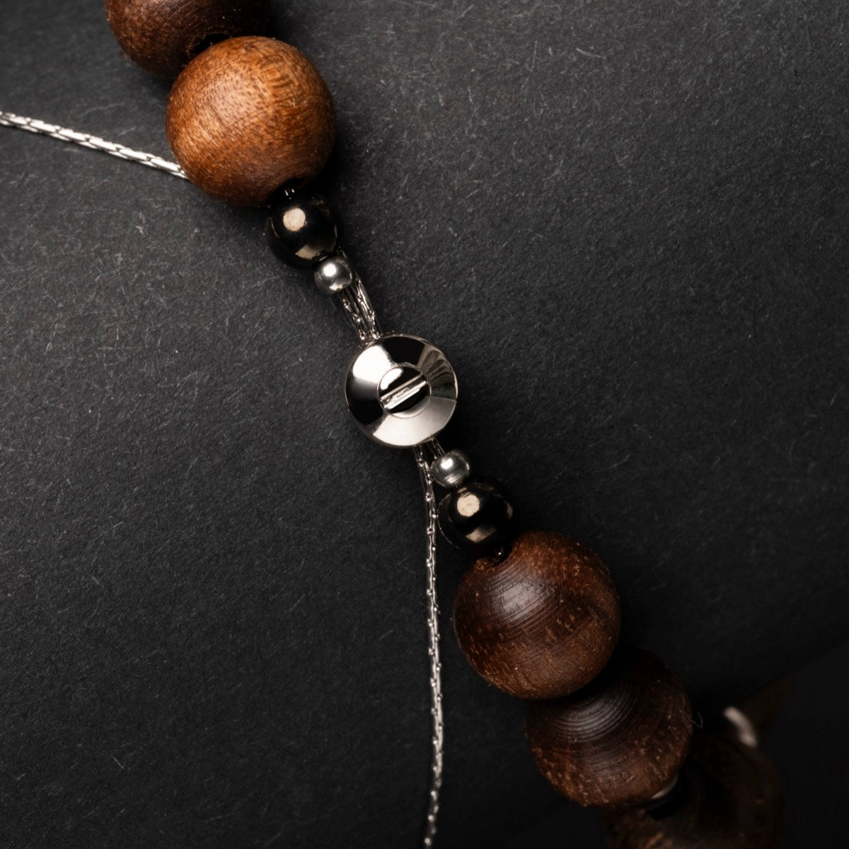 "Superset" necklace featuring Hematite and Walnut beads with an elegant, modern design.