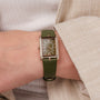"Memoire" watch with a green leather strap and rectangular dial, showcasing elegant and stylish design.