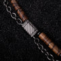 "Supersonic" bracelet featuring zebrawood and gray chain with intricate detailing.
