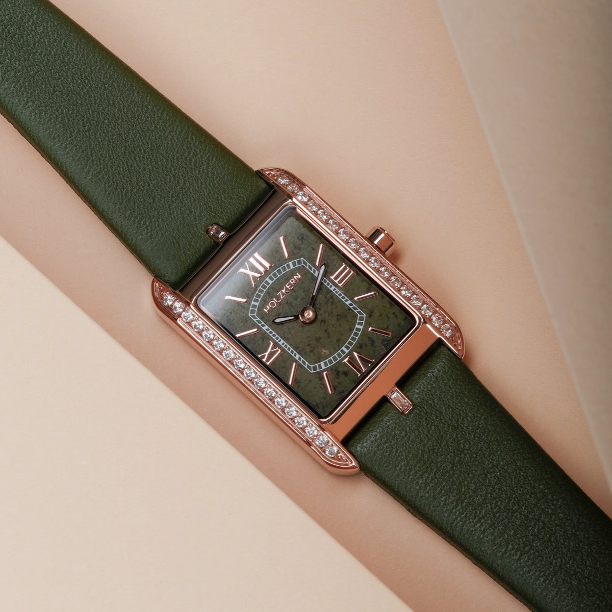 "Memoire" watch featuring a rectangular face with green accents and a luxurious leather band.